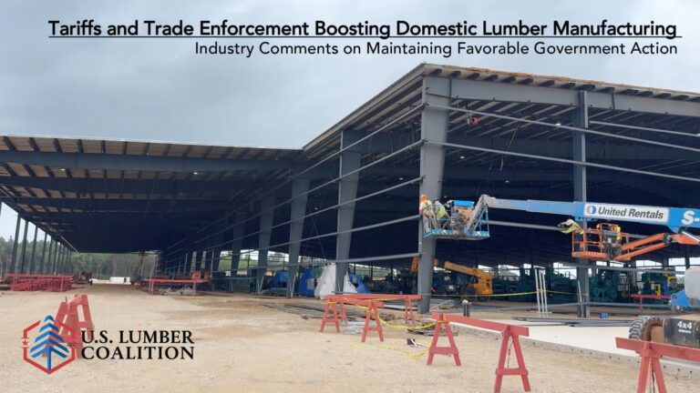 Partially constructed industrial building with steel beams, construction equipment, and workers on lifts, under an overcast sky. U.S. Lumber Coalition logo in lower left corner.